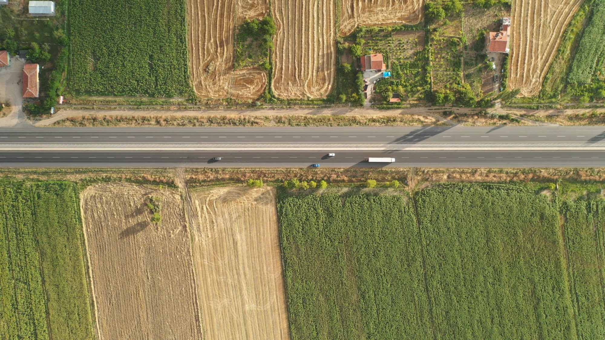 Aerial view of a rural road running between farm fields