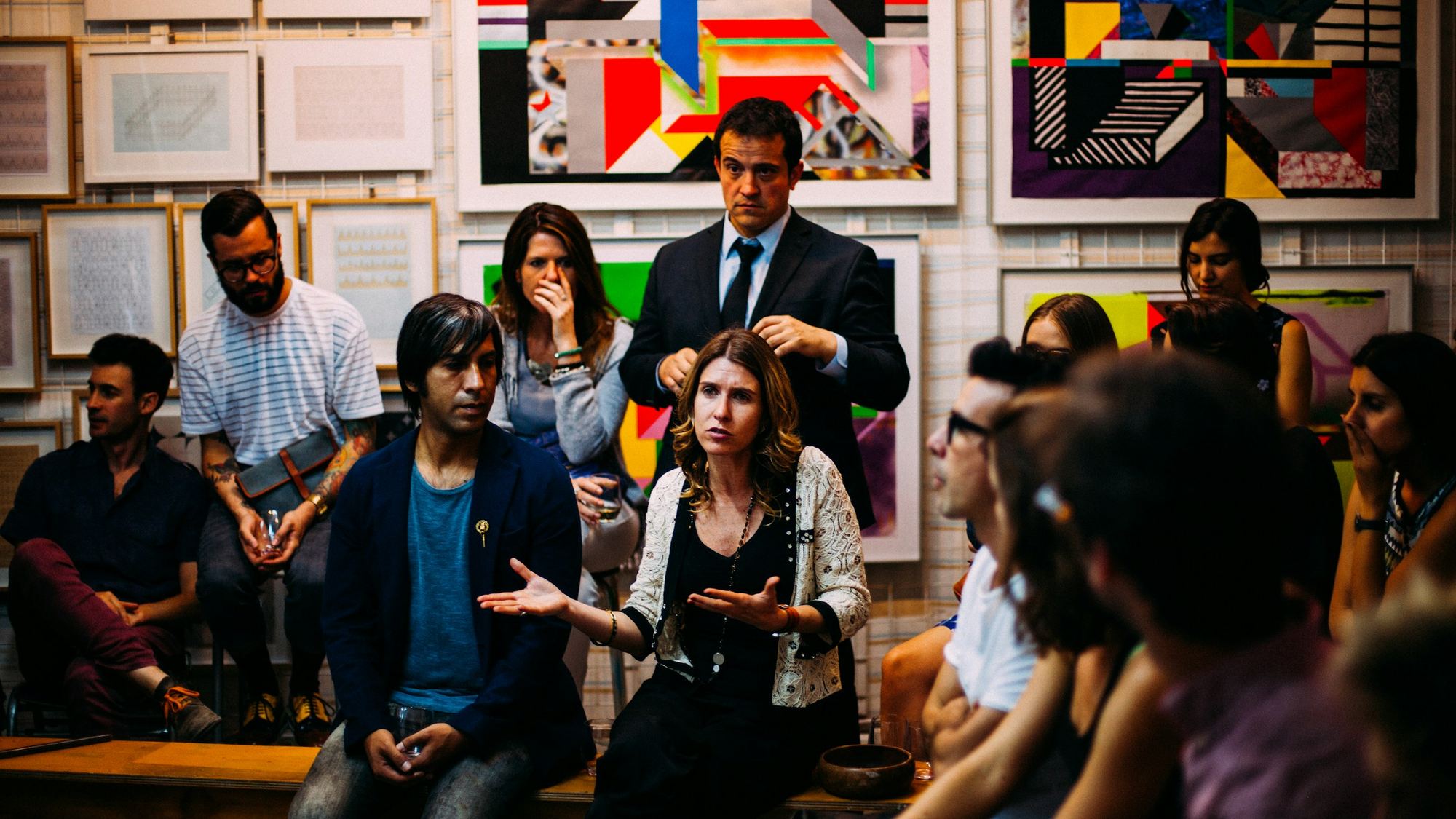 A group of people sit and stand together during a lively meeting