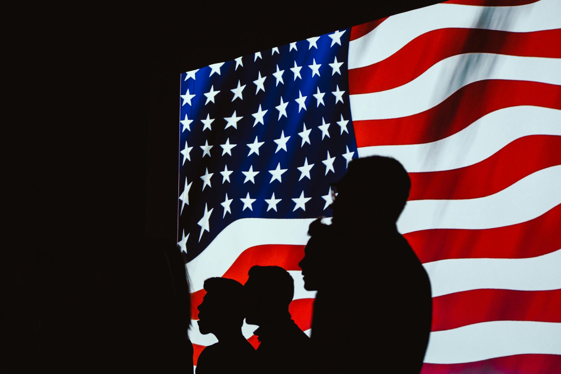 Silhouettes of people with American flag