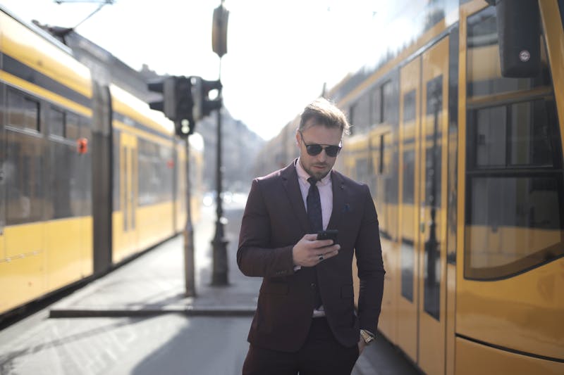 Businessman using smartphone for text marketing