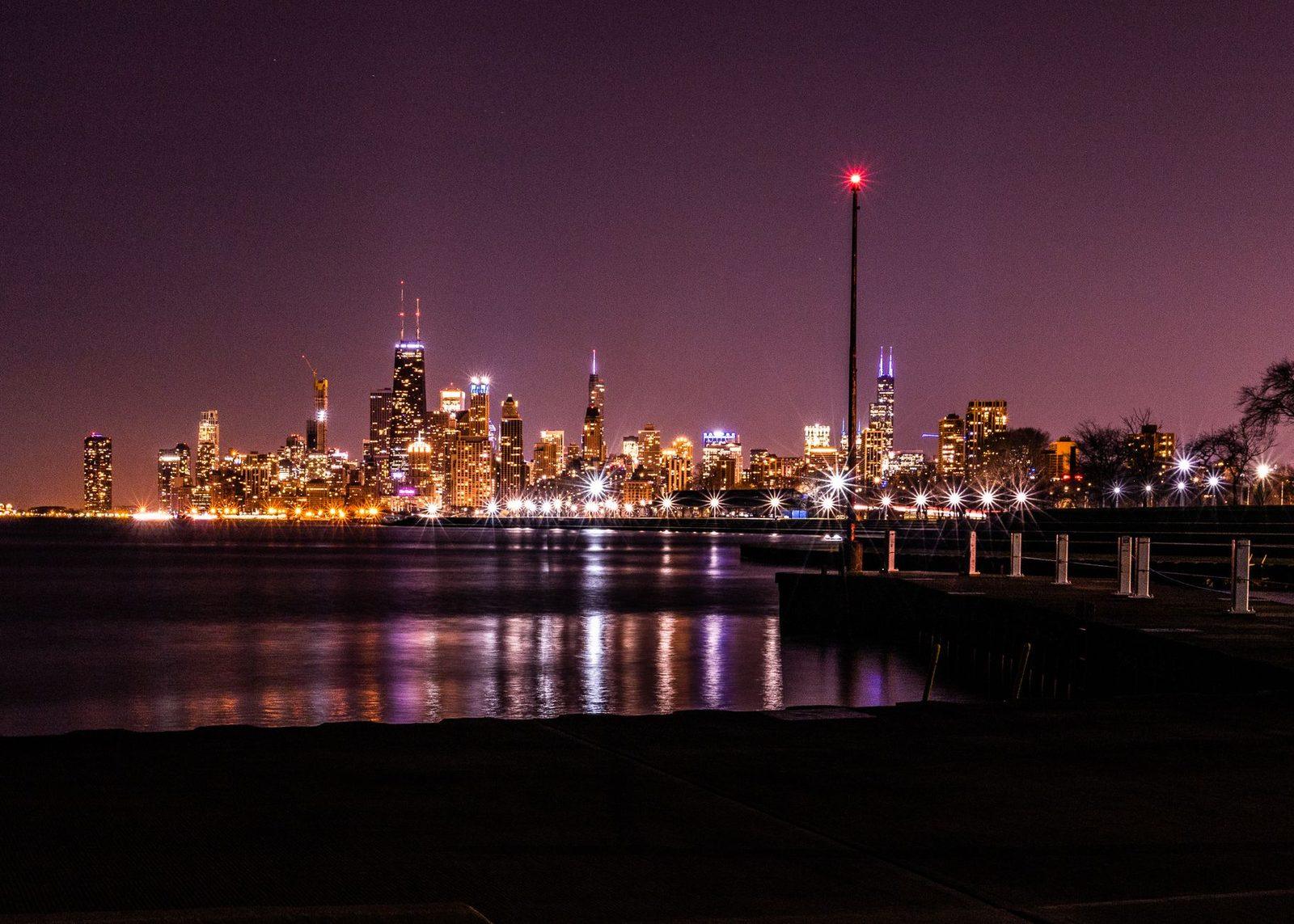 The Chicago skyline lit at night with reflections on Lake Michigan, the largest metro in a twelve-state Midwest business texting footprint
