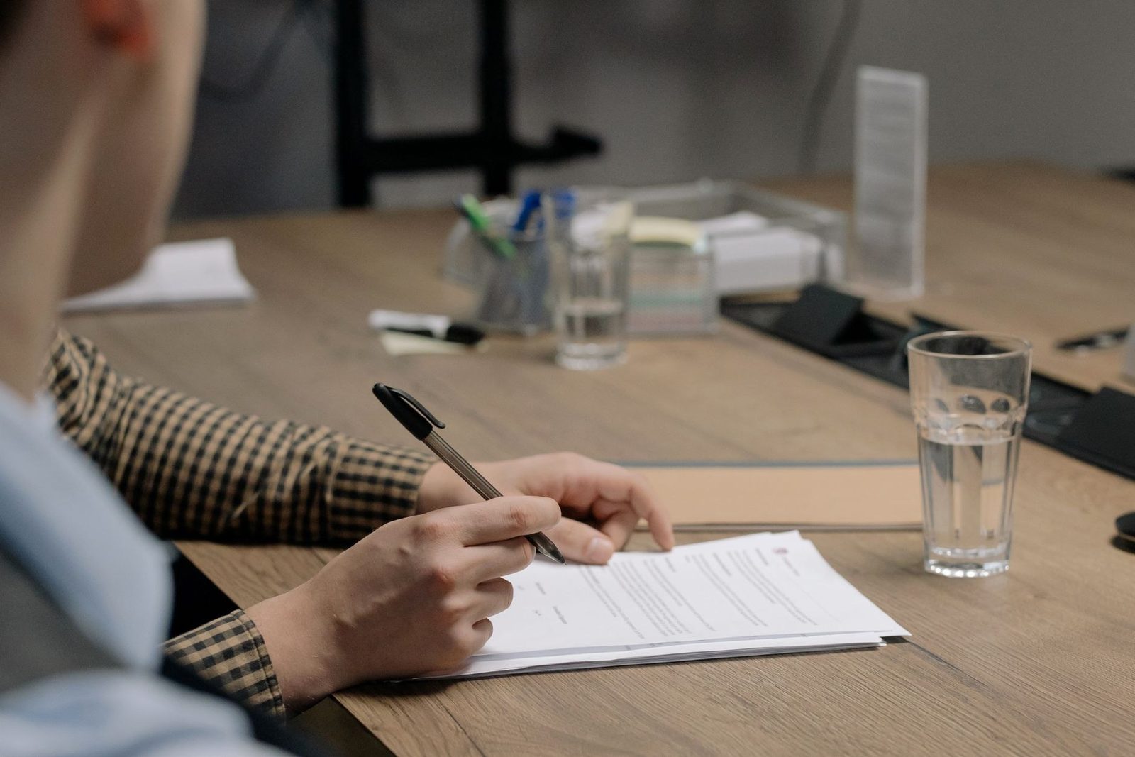 Paperwork being signed at a desk, the consent and carrier registration records a texting program keeps