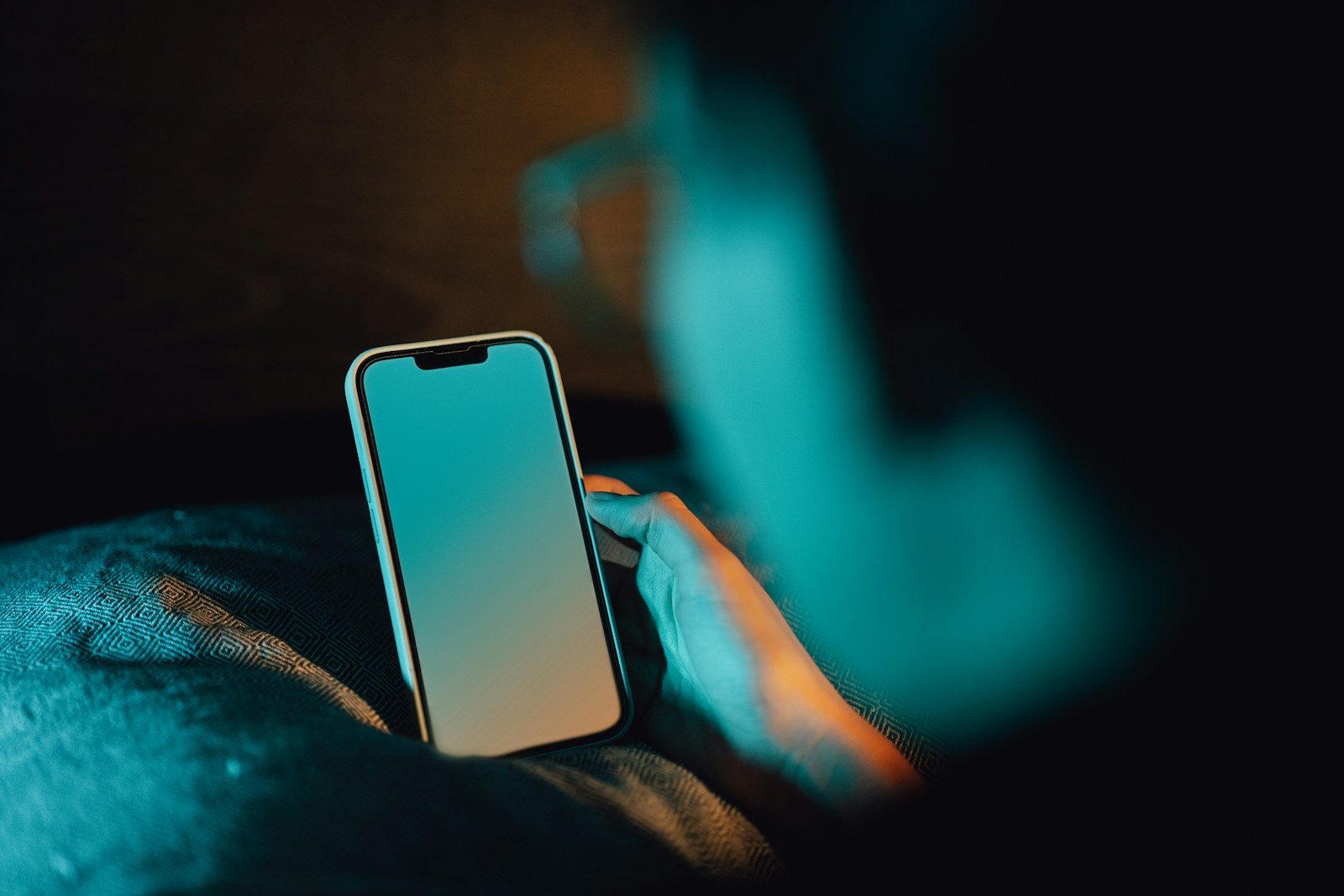 Hand holding a smartphone mid-conversation, a customer replying to a two-way SMS marketing message