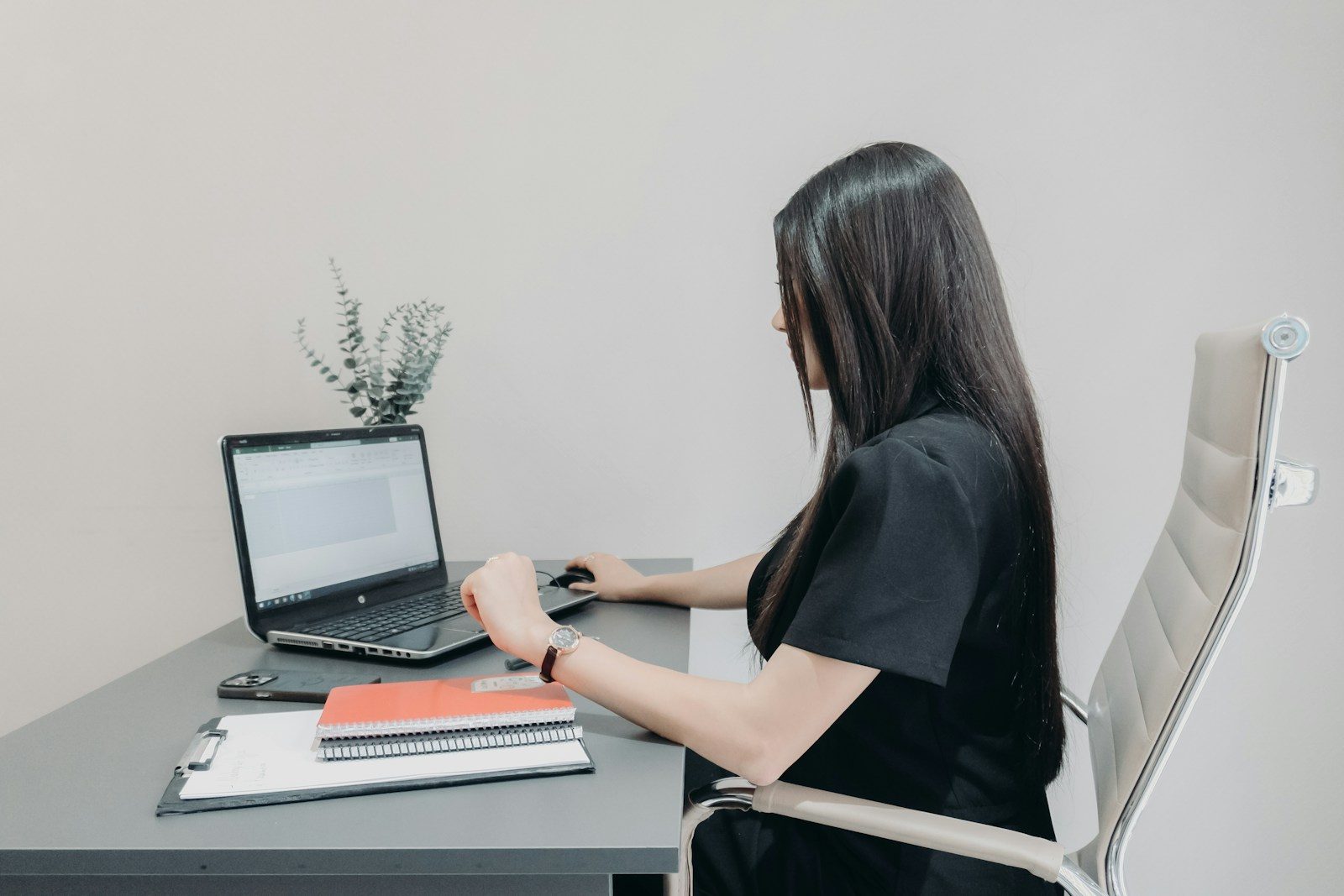 Onboarding specialist at a workspace with a laptop and notebooks: careful white-glove SMS marketing and 10DLC setup work