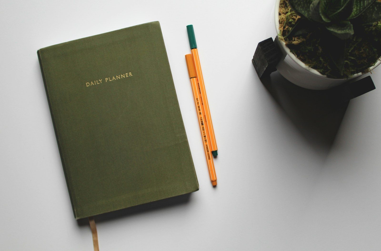 Open planner book and pen on a desk: scheduling SMS automation runs and quiet-hour windows