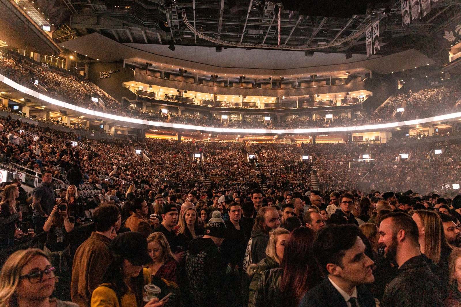 A packed arena crowd, the audience scale a single mass-texting broadcast reaches at once