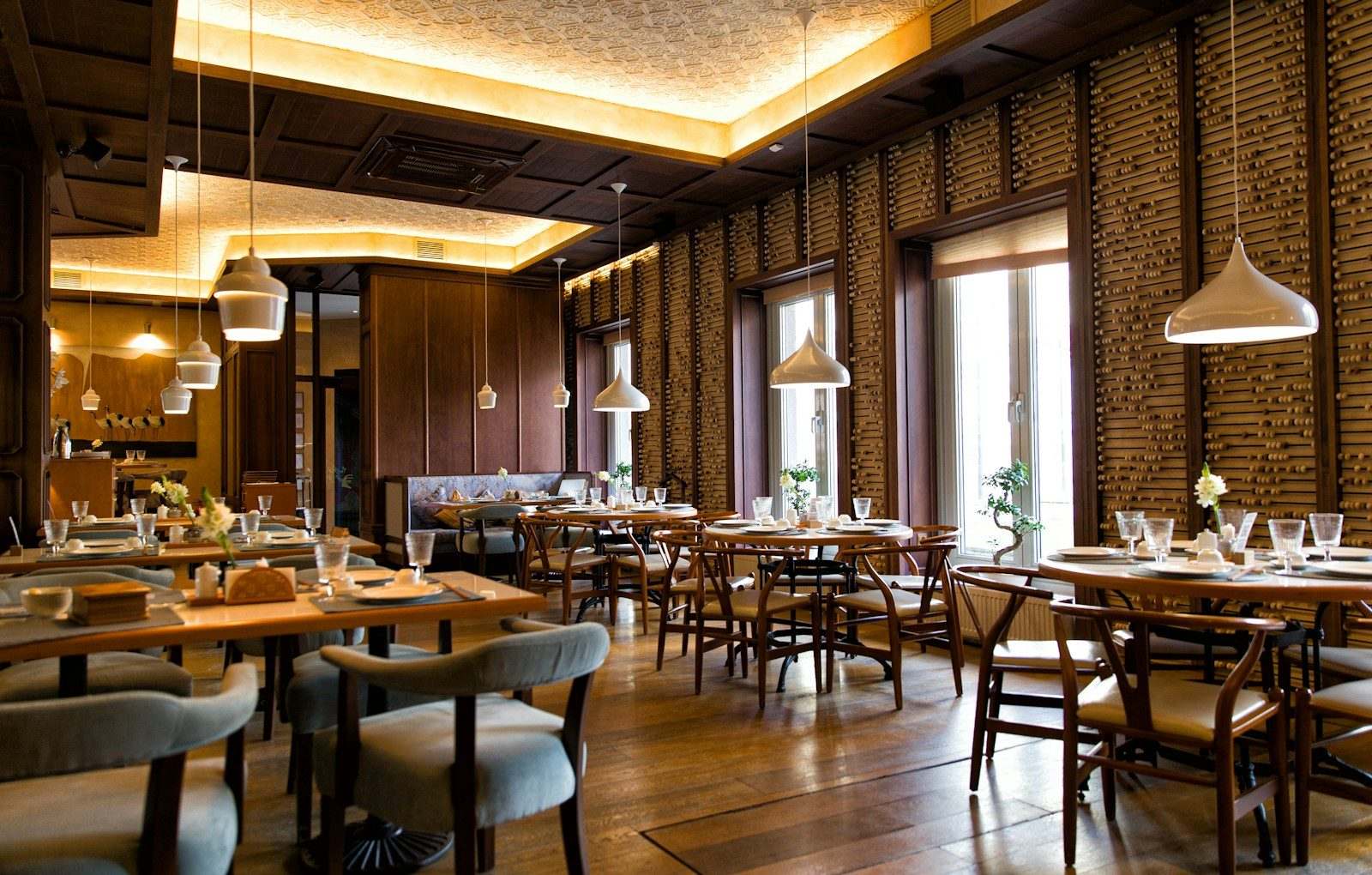 Restaurant dining room set for service, the front-of-house operation that runs SMS marketing through CampaignCNX+