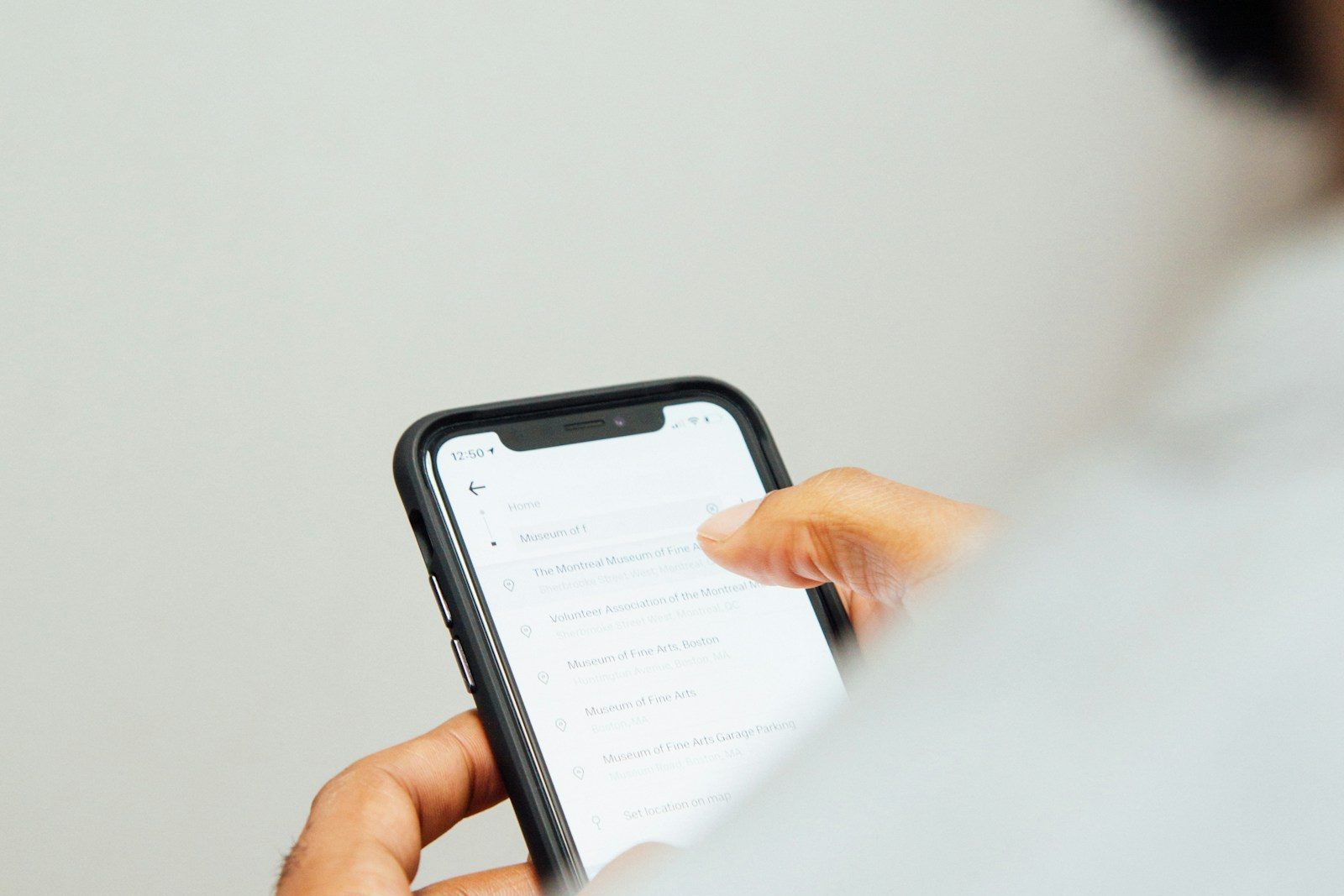 Smartphone showing an incoming SMS marketing message, the high-open-rate channel in the SMS-vs-email comparison