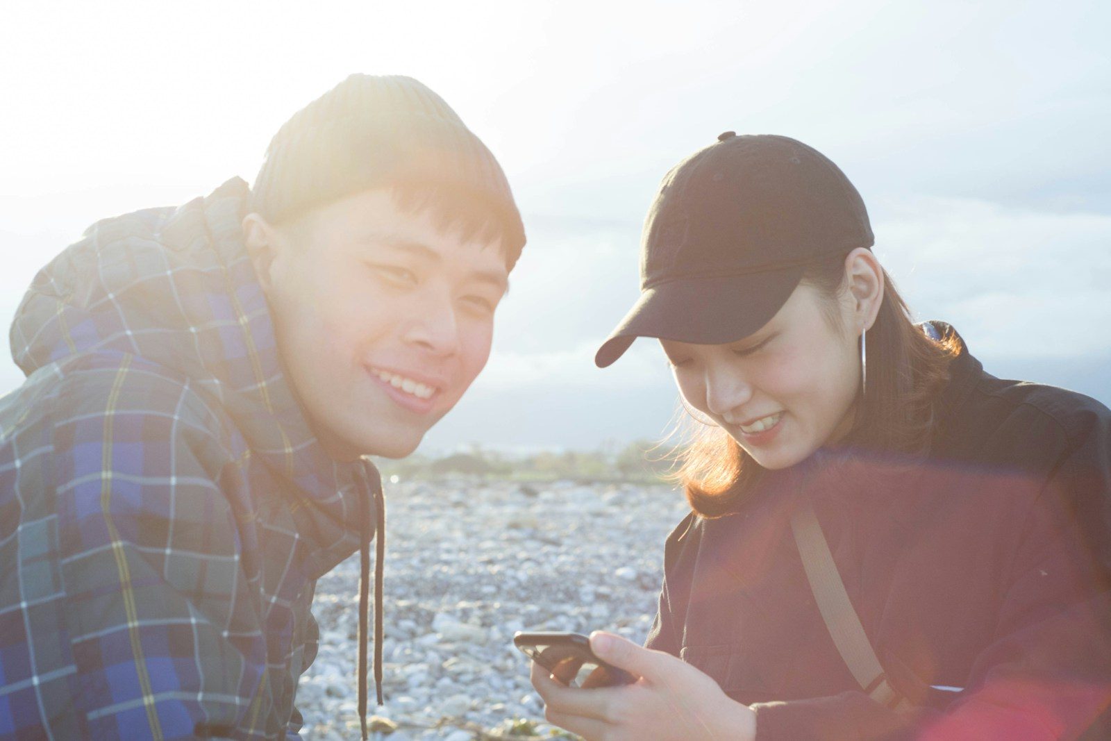 Two people side by side, one replying to a text message: the two-way SMS conversation that turns a broadcast into a real customer relationship