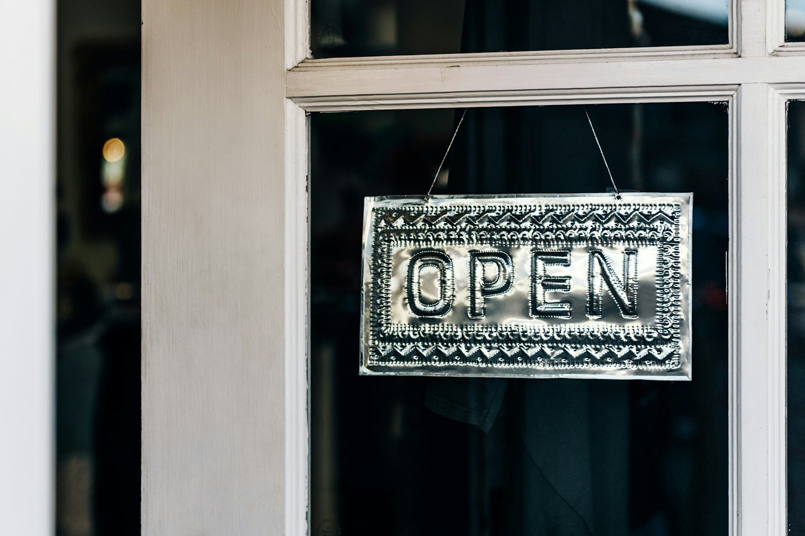 Welcome sign at a small-business entrance, loyalty customers who receive SMS marketing texts